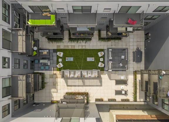 an overhead view of a building with a courtyard and a lawn
