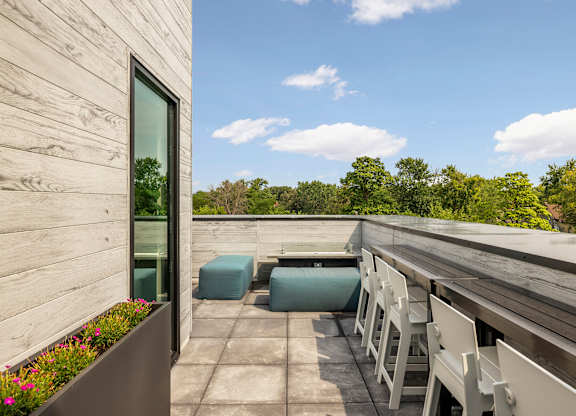 A wooden deck with chairs and a table.