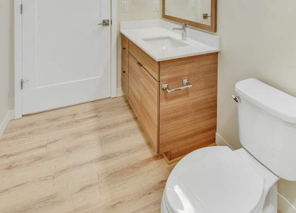 A white toilet sits next to a sink in a bathroom.