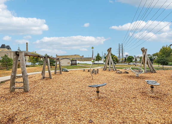 A playground with wooden swings and slides.