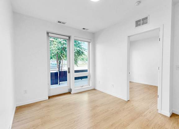 A room with a window and a door.