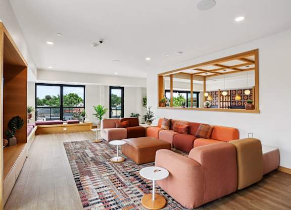 A living room with a large couch and a rug.