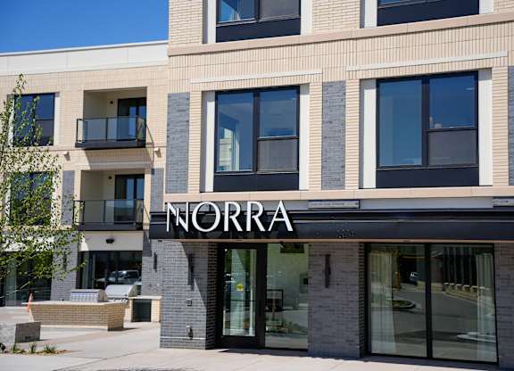 The front of a building with the word "NORRA" on it.