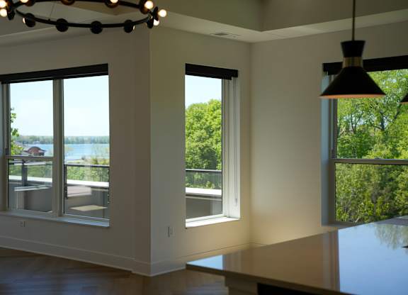 A modern room with a view of the water through the windows.