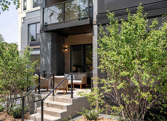 A modern house with a glass door and a balcony.