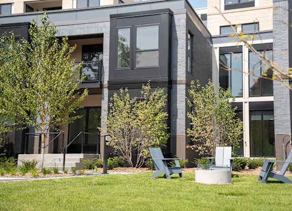 A modern building with a green lawn in front.