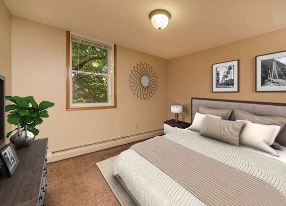 A bedroom with a bed, nightstand, lamp, and pictures on the wall.