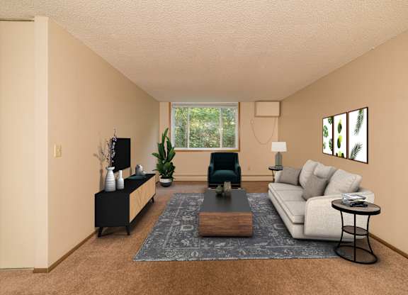 A living room with a white couch, a coffee table, and a green chair.