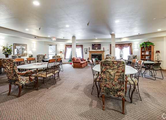 A large room with a dining table and chairs.