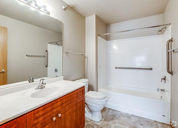 A bathroom with a toilet, sink, and bathtub.