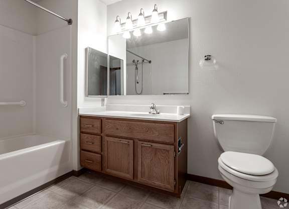 A white toilet sits next to a sink in a bathroom.