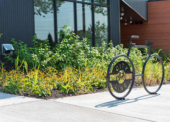 A bicycle is parked in front of a building with a sign that says "CITY LINE".