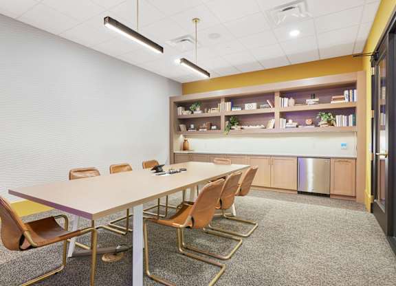 A conference room with a long table and chairs.