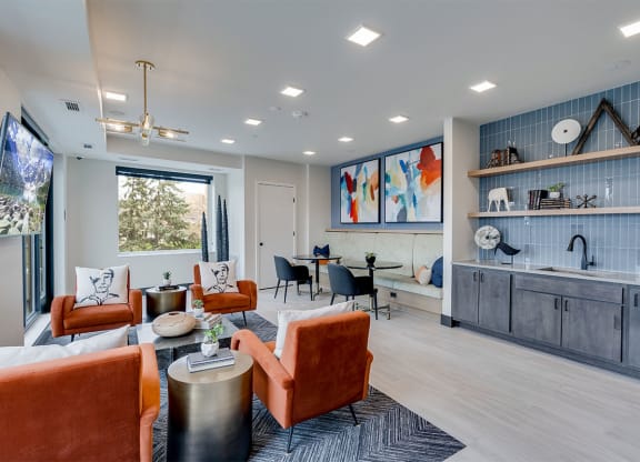 Lounge area with tv and orange chairs