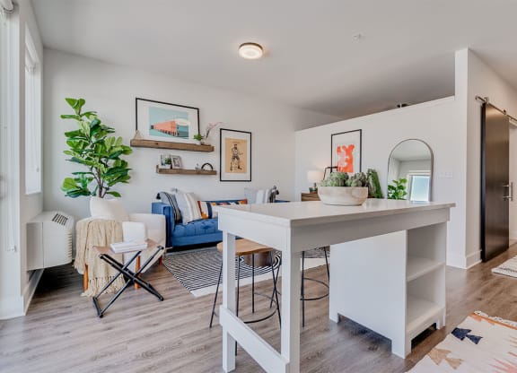 an open kitchen and living room with a white counter top