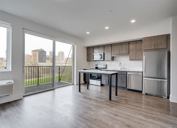 Open concept kitchen with brown cabinets and stainless steel appliances
