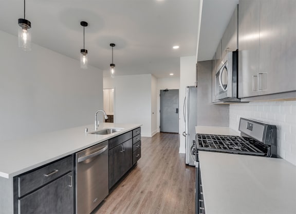 Large kitchen with black light fixtures