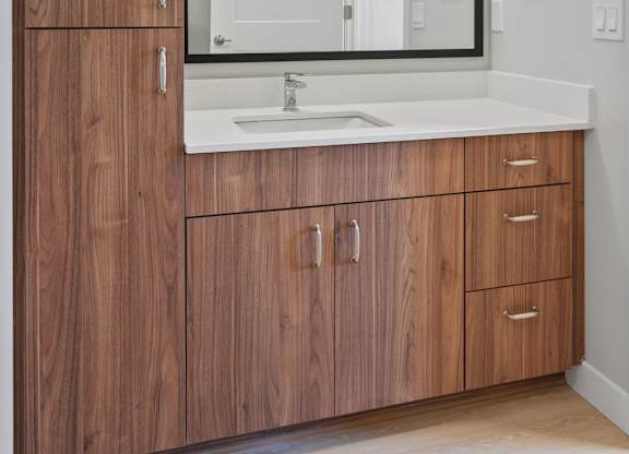 A bathroom vanity with a sink and mirror.