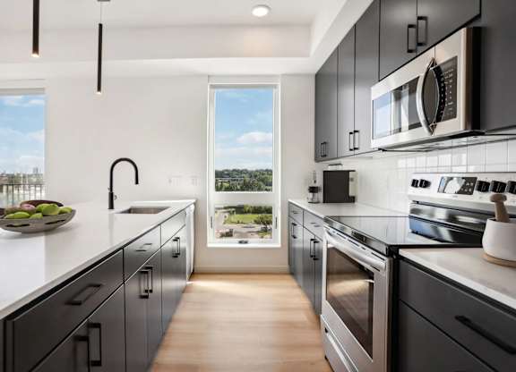 A modern kitchen with a view of the city.