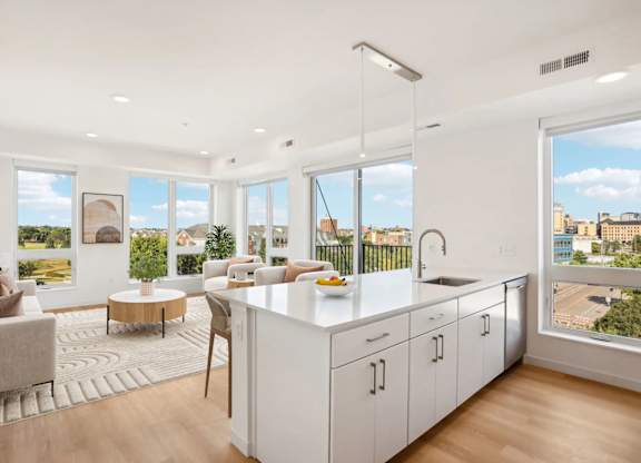 A modern kitchen with white cabinets and a large island.