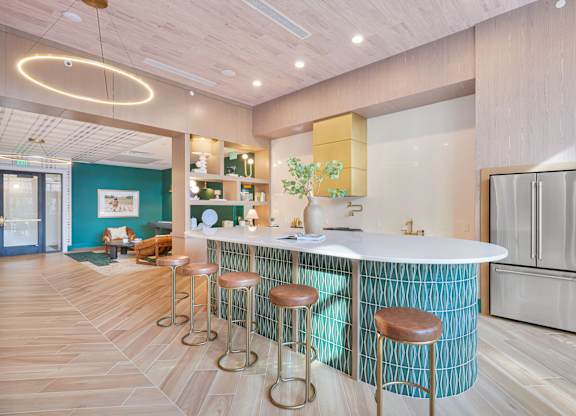 A bar area with a white counter and brown stools