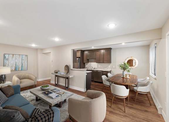 A modern living room with a dining area and kitchen in the background.