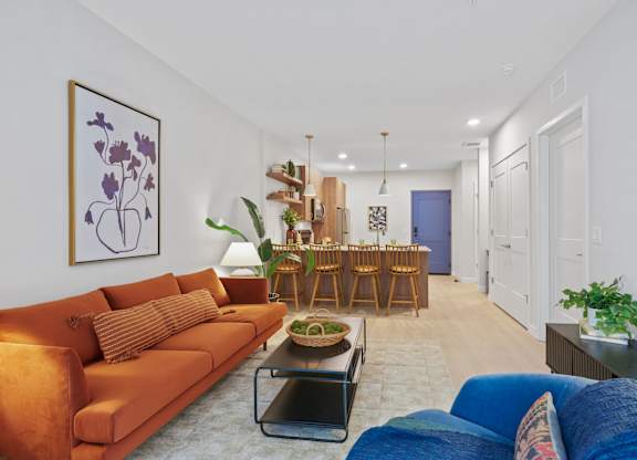 A living room with a blue couch and a brown sofa.