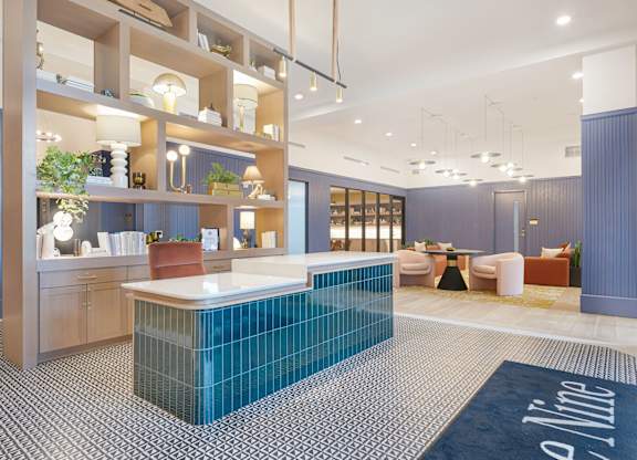 A modern office space with a reception desk and seating area.
