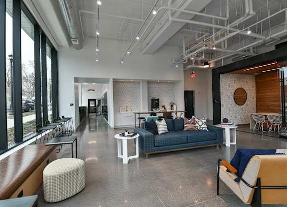 A modern living room with a blue couch and a white coffee table.