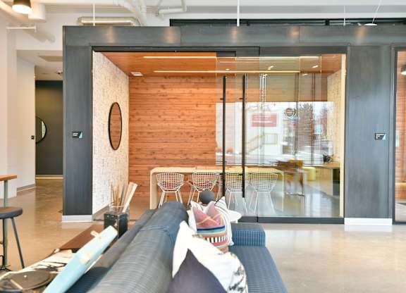A modern living room with a couch and a skateboard on the floor.