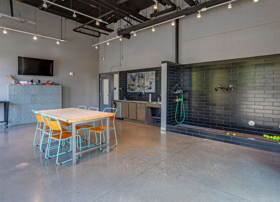 a table and chairs in a room with a brick wall