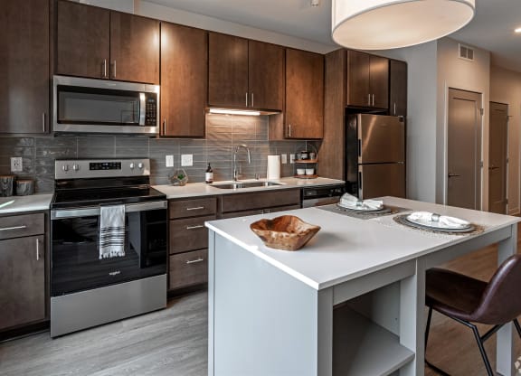 a kitchen with stainless steel appliances and wooden cabinets