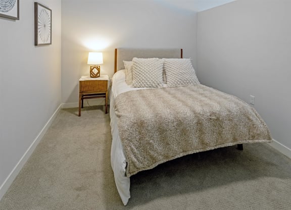 a bedroom with a bed and a night stand