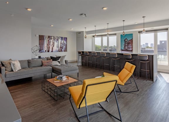 a living room with couches and chairs and a bar