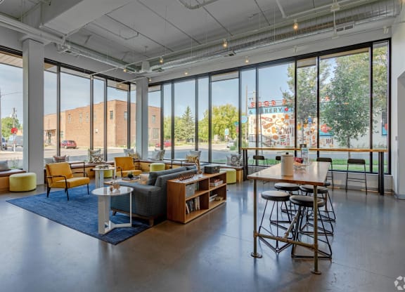 a living room with glass walls and a view of a playground