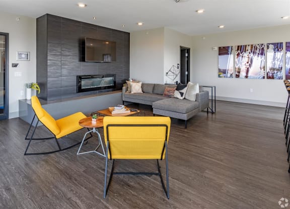 a living room with yellow chairs and a couch
