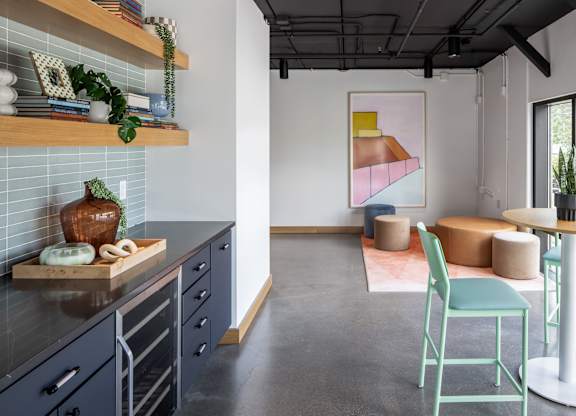 A kitchen with a cutting board on the counter.