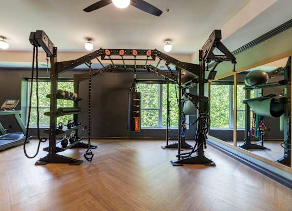 A gym with a wooden floor and a mirror on the wall.