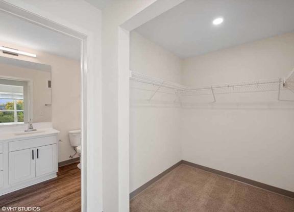 a bathroom with a sink and a toilet in a white room