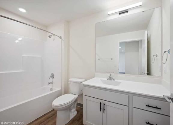 a bathroom with a sink and a toilet and a mirror