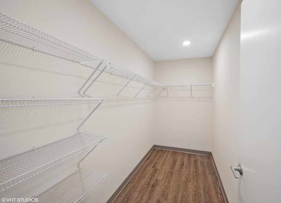 the ceiling of a room with white and gray wallpaper and wooden floors