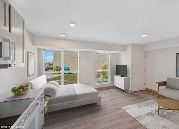 a living room with a couch and a bed and a tv