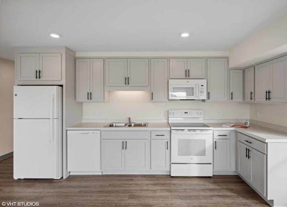 a white kitchen with white appliances and white cabinets