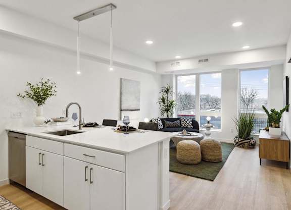 A modern kitchen with white cabinets and a large island.
