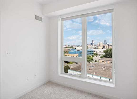 A large window with a view of a cityscape.