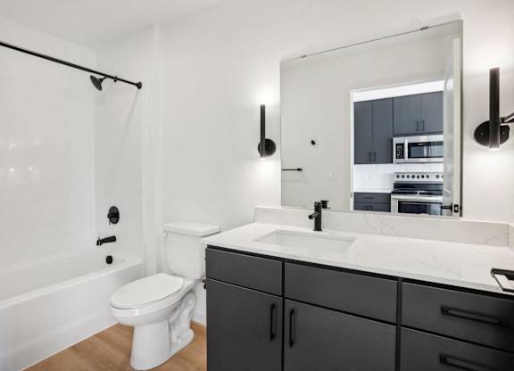 A bathroom with a white toilet and a white sink.