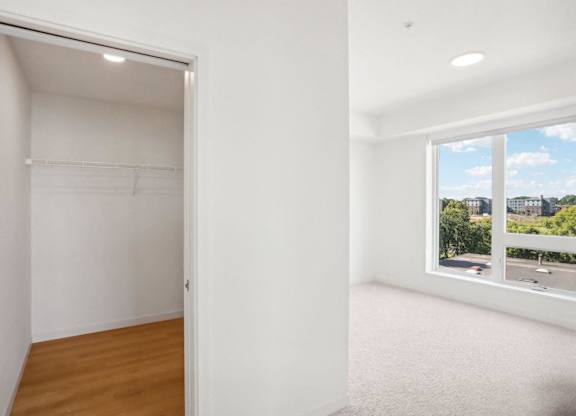 A room with a large window and a view of the city.