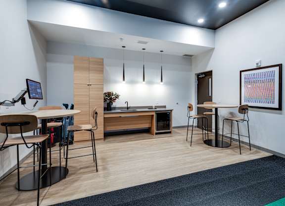A modern office space with a desk, chairs, and a computer monitor.