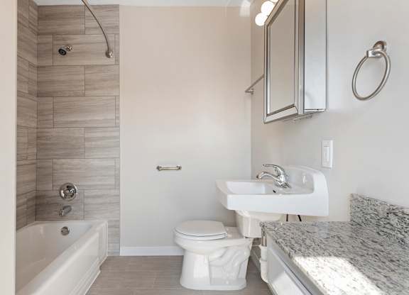 A white toilet sits next to a sink in a bathroom.