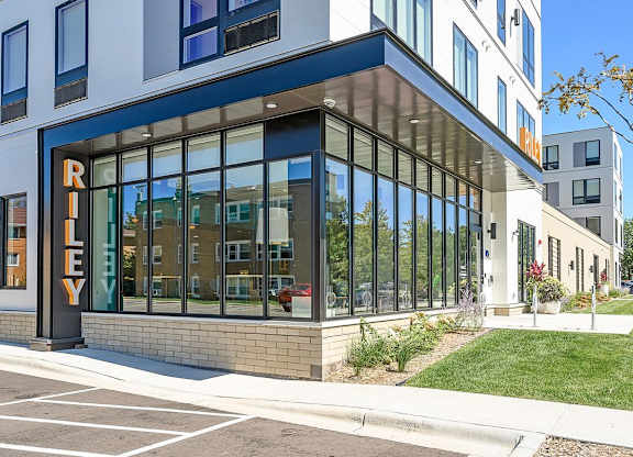 A modern building with a glass facade and a sign that reads "RILEY".